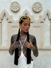 woman standing in unique bacground wearing Tamoe Silk Harness Skirt in White and Khutulun Headband gold with 22" Tassel Gold-Black by Object&Dawn