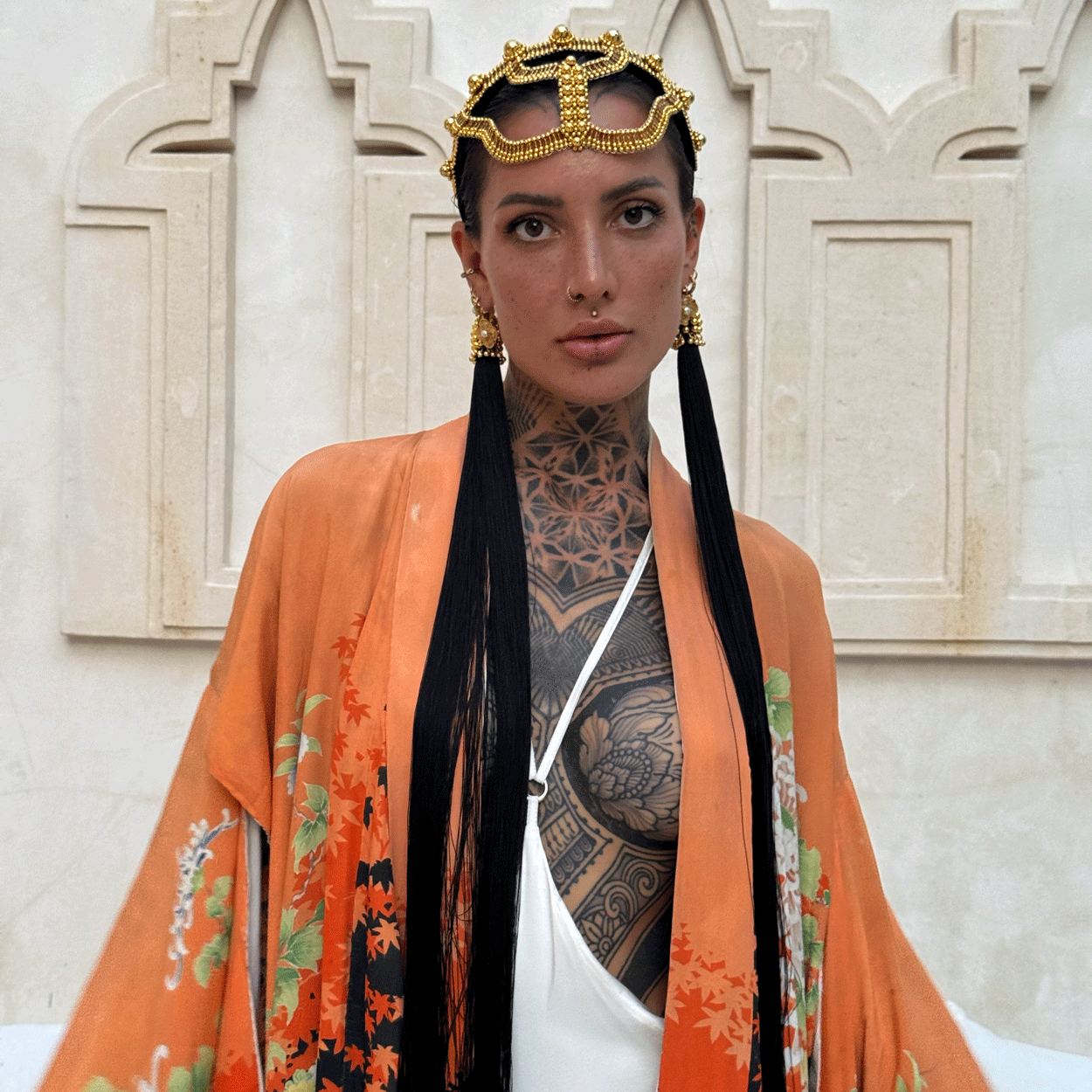 woman standing in unique bacground wearing Tamoe Silk Harness Skirt in White with Antique Kimono and Khutulun Headband gold with 22" long Tassel Gold-Black  by Object&Dawn