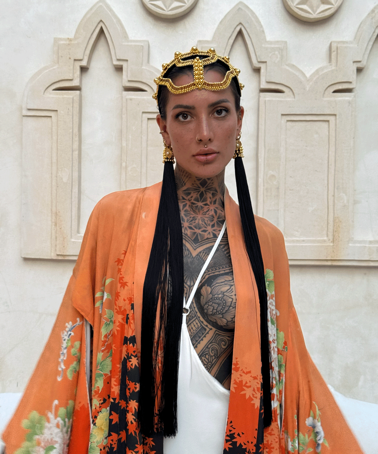 woman standing in unique bacground wearing Tamoe Silk Harness Skirt in White with Antique Kimono and Khutulun Headband gold with 22" long Tassel Gold-Black  by Object&Dawn