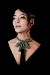 beaded bow modular choker silver by object and dawn worn by woman in black outfit