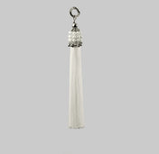 Beaded handcrafted polyester tassel by silver coated metal beads with systethic japanese pearl on grey background