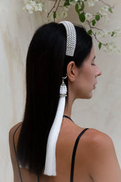woman in black outfit wear handcrafted beaded modular headband with polyester tassels by object and dawn back view