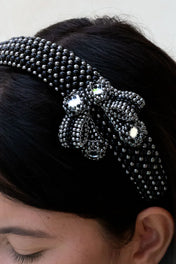 close up of woman with handcrafted Silver beaded  with black crystals amaya headband  by Object & Dawn worn by a person with a neutral background 