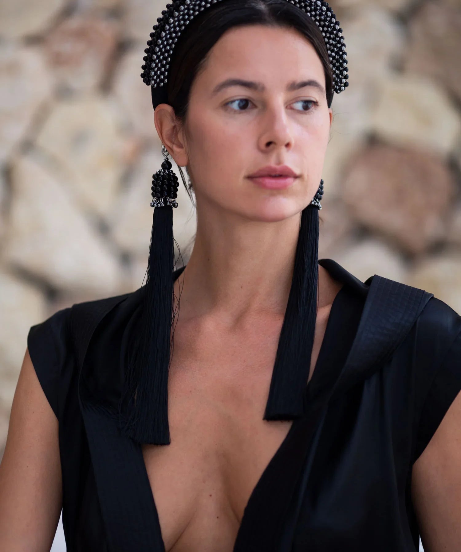 Beaded handcrafted polyester tassel by silver coated metal beads with black crystals with modular headband on grey background