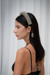 Woman showing left side wear Anais Headband silver on neutral background by Object&Dawn