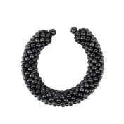 modular beaded wrist accessory in ivory, structured supple cuff with polymer metal beads, ghost image front view