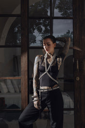 woman lean on the glass windows using V-Neck Beaded Harness w/ Collar Stand silver in black outfit by object & dawn