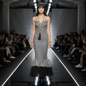 Woman walking on a fashion show runway wearing a gray dress with Beaded Link Necklace by Object & Dawn