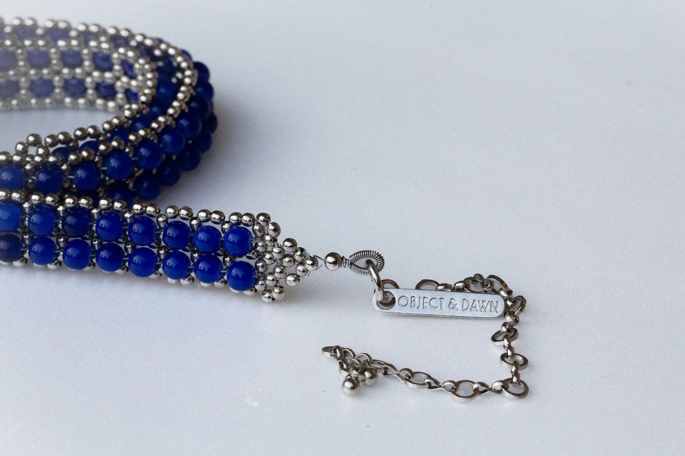 Handmade beaded blue crystals with polymer metal beads by object and dawn close up