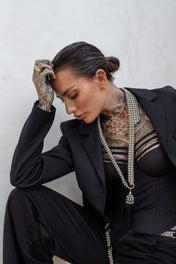 woman in black coat wearing beaded tailored colar with removable tassel silver by object & dawn