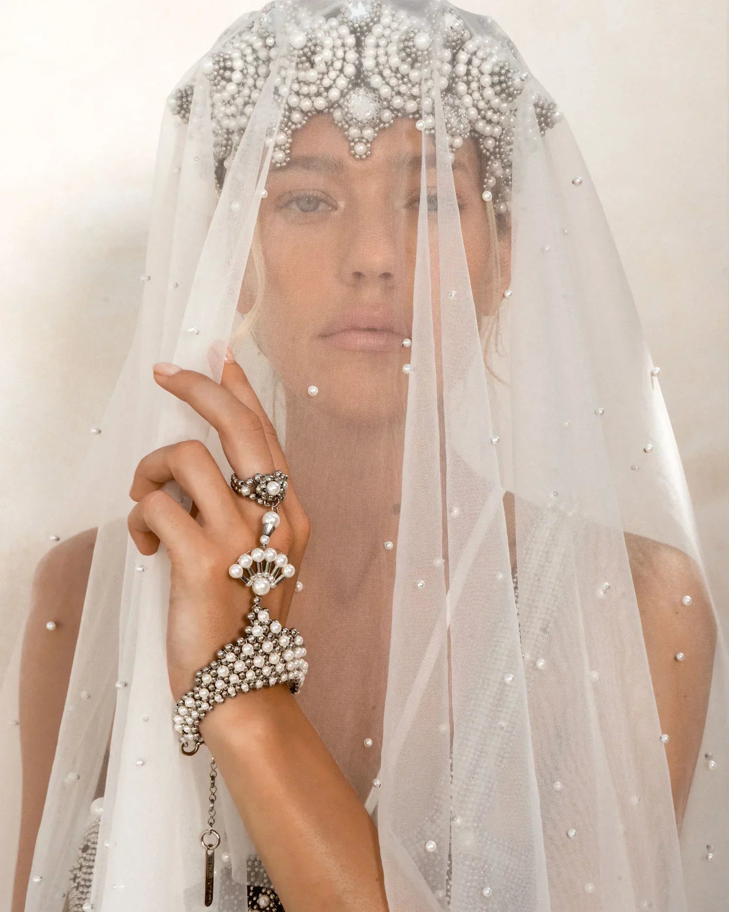 A blond bride is wearing a sheer veil over the Eingana Crown and pearl bracelet & ring combo by Object & Dawn. 