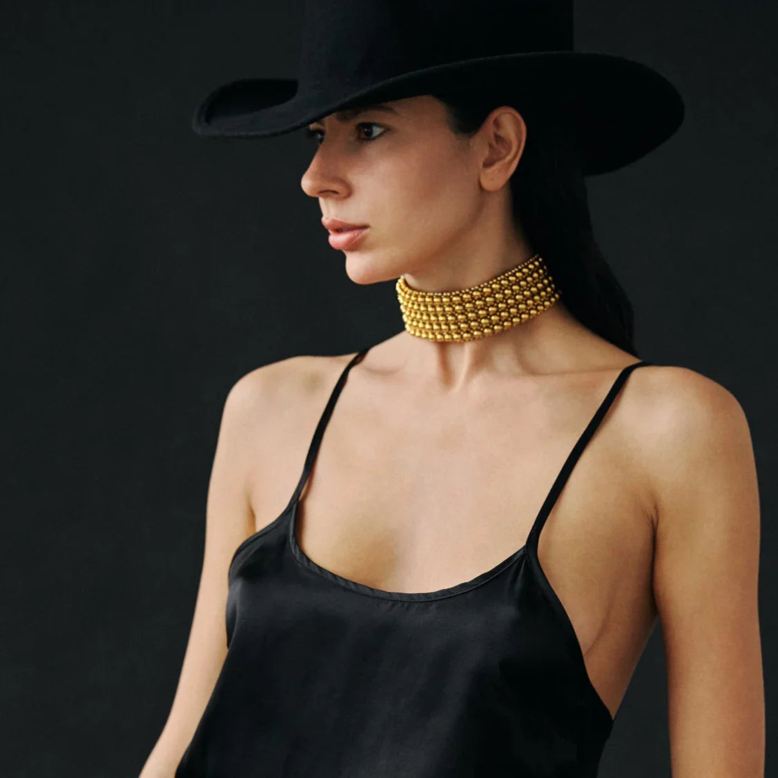 woman with black hat with handcrafted beaded choker in 22k plated beads by object and dawn