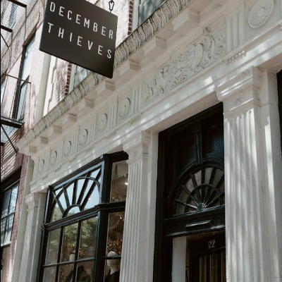 Building facade with 'December Thieves' sign above entrance