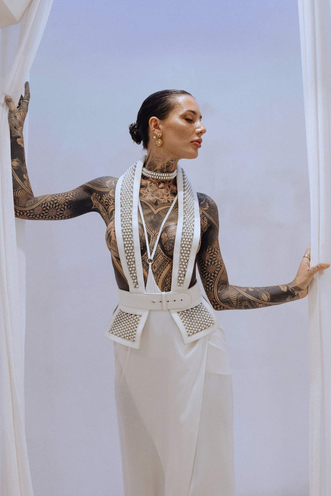 Woman wear Dietrich Tuxedo Vest with Tamoe Silk Harness Skirt in white, modern bridal fashion by Object & Dawn 