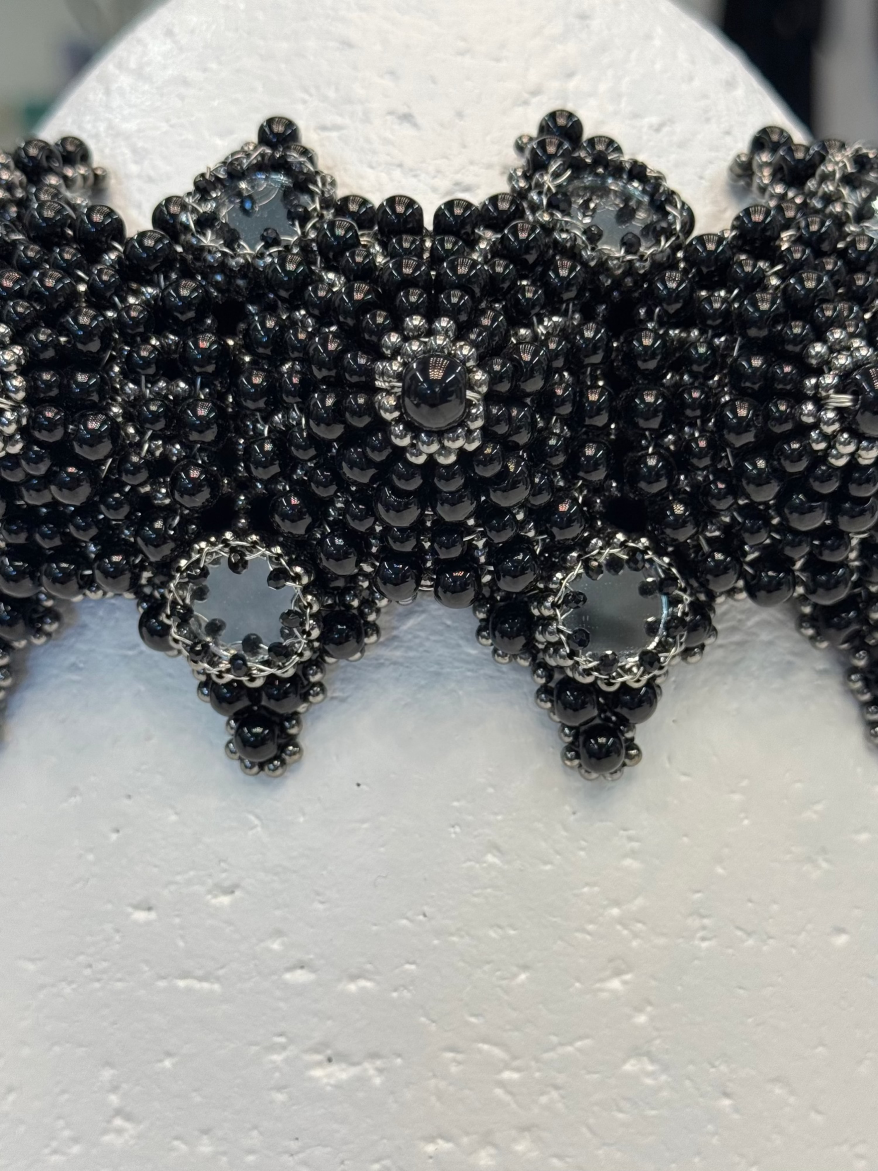 handcrafted modular crown with silver coated polymer beads and black crystal by object and dawn ghost image in white background close up view