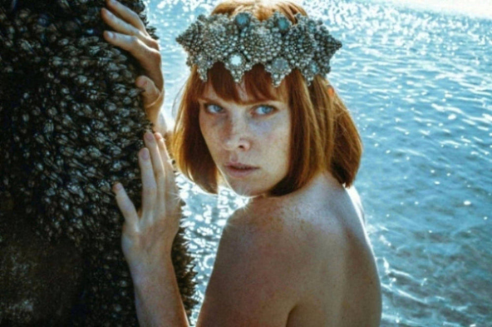 woman with sea background has red hair wears eingana crown in silver by object and dawn