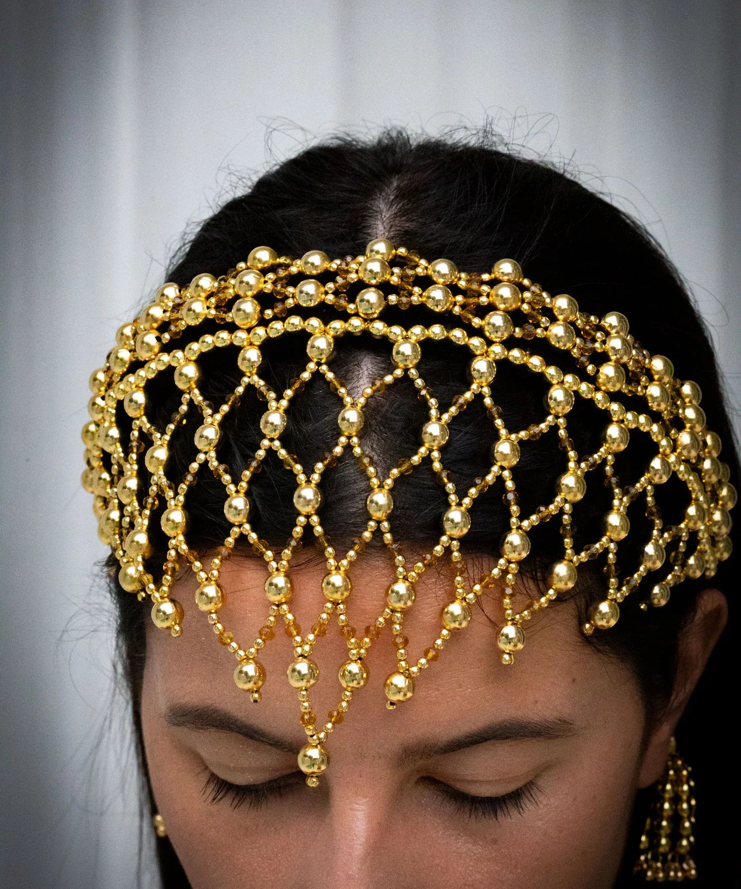 close up handcrafted modular beaded headband by object and dawn with 22k gold wash