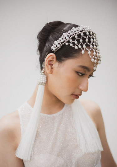 East asian bride wearing Freja Headband in Pearl with two white 11" tassels. 