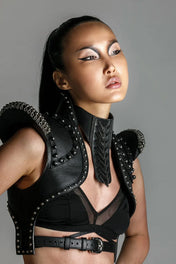 woman with beaded premium leather helios bolero jacket by object and dawn in grey background front view