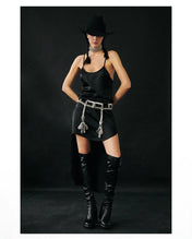 woman standing wearing black hat with black leather boots and black teuta dress celestial choker and teuta belt in silver by Object & Dawn on a black background