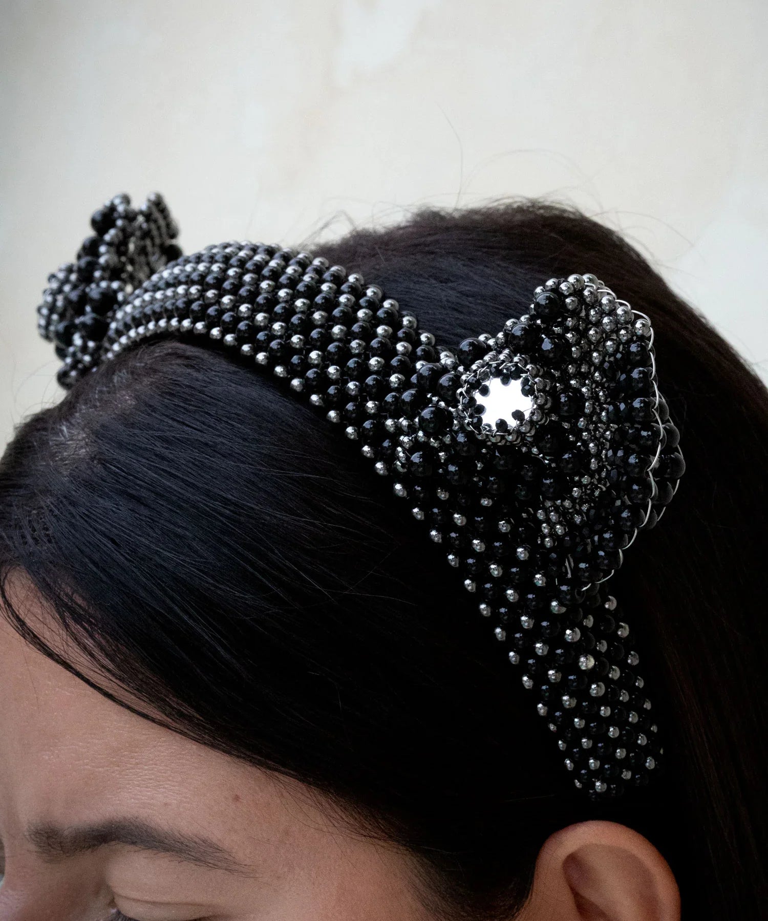 textured view of Jet black beaded Jas headband worn by a person with a neutral background by Object & Dawn