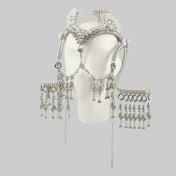 Object and Dawn, modular headpiece system in pearl with removable mask and pearl cowrie tassels in grey background, ghost image front on mannequin diagonal view
