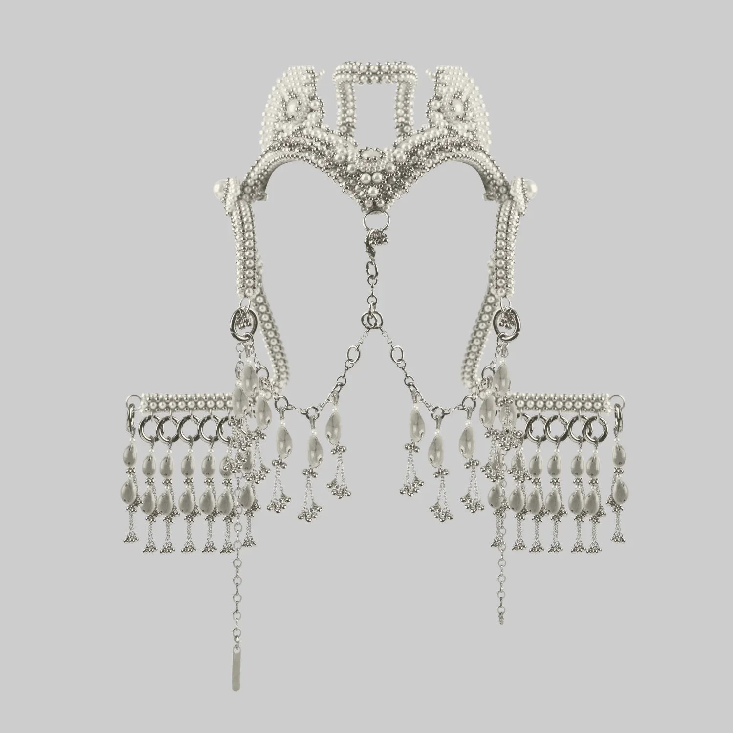 Object and Dawn, modular headpiece system in pearl with removable mask and pearl cowrie tassels in grey background, ghost image front