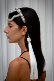 woman wearing handcrafted pearl beaded Khutulun headband in minimal studio setting side view