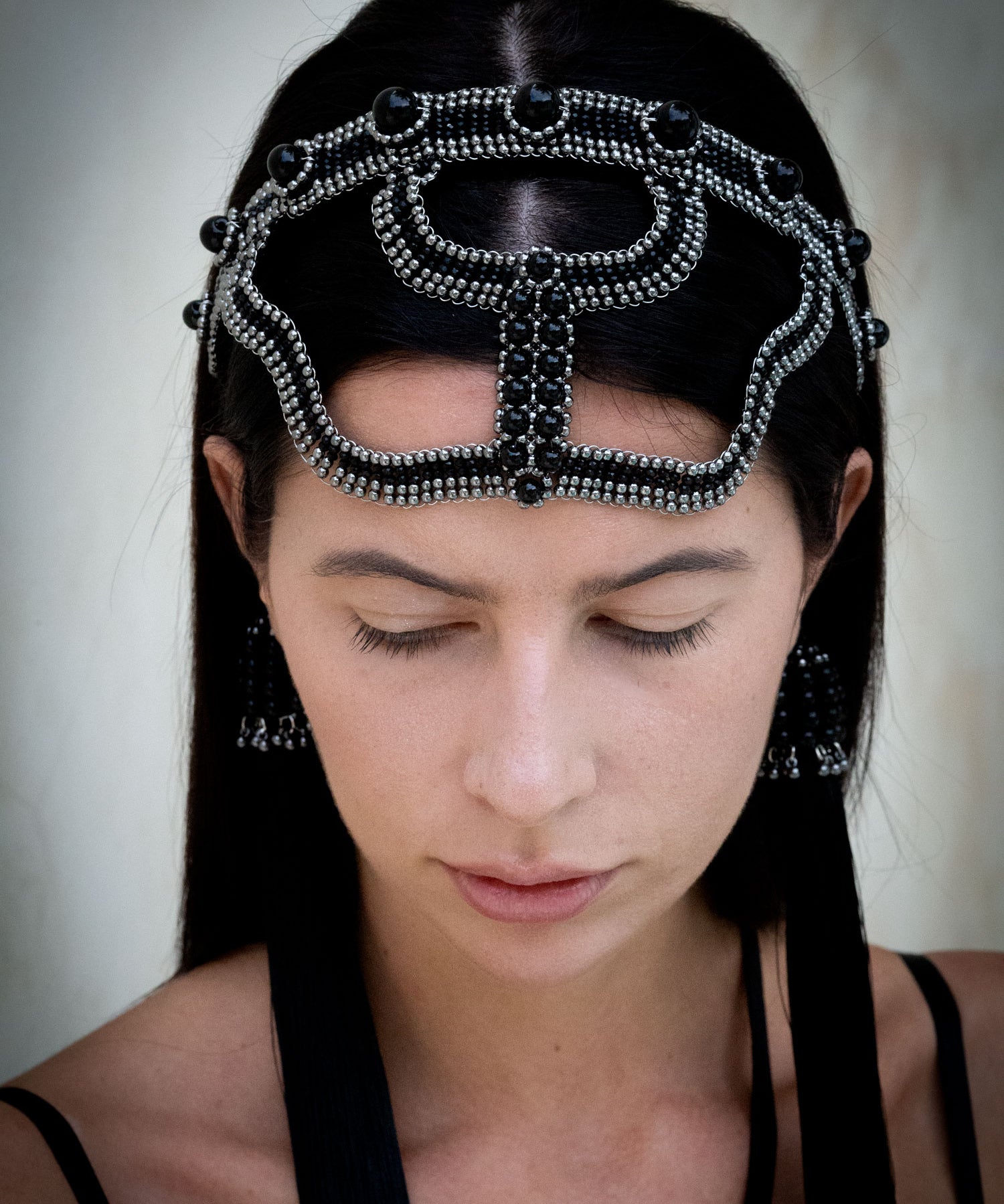 woman with black hair wearing modular beaded headband black in neutral background