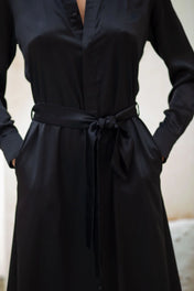 woman in black anais long sleeves silk maxi dress by object & dawn stand in neutal background close up view