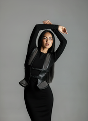 Woman wearing a black outfit with Lister Beaded Bodice and Girdle by Object & Dawn against a gray background