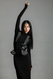 Woman wearing a black outfit with Lister Beaded Leather Girdle Belt Bodice by Object & Dawn on a gray background