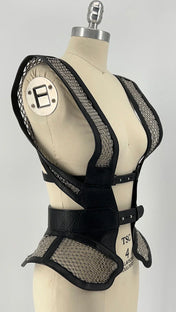 Black beaded mesh and leather top on a mannequin diagonal view