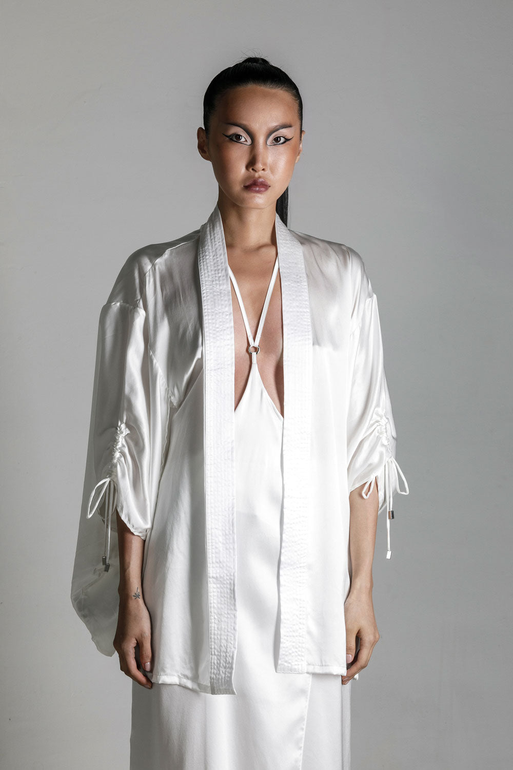 east asia woman wear Mineko Short silk kimono with tamoe silk harness skirt win white on netural background by object & dawn