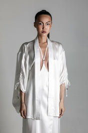 east asia woman wear Mineko Short silk kimono with tamoe silk harness skirt win white on netural background by object & dawn