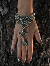 luxury beaded hand jewelry polymer metal beads silver on hand with wood background by object and dawn