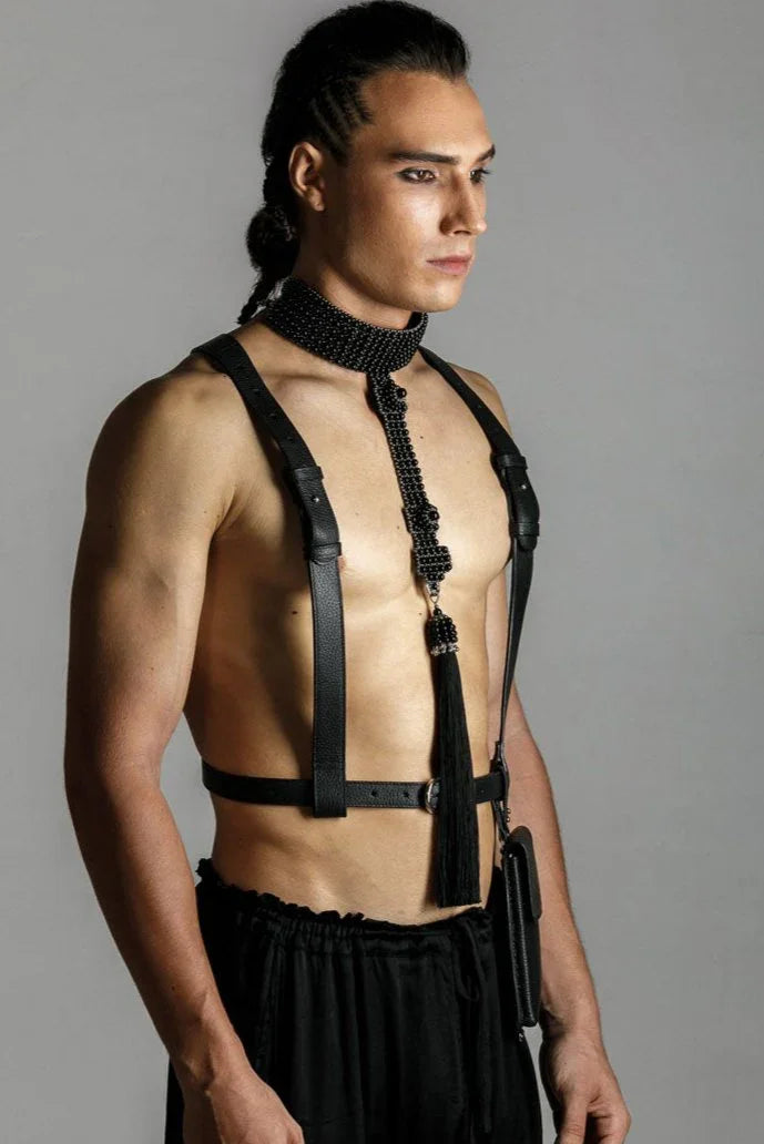 man wears elohim t-choker in jet black with leather harness black by object and dawn standing against grey background