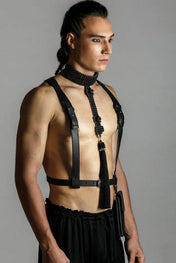man wears elohim t-choker in jet black with leather harness black by object and dawn standing against grey background