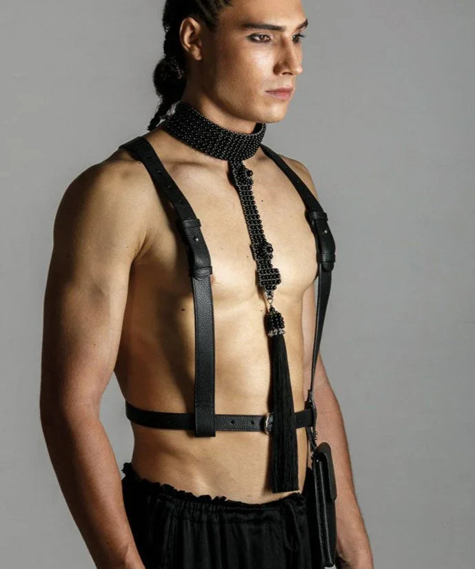 man wears elohim t-choker in jet black with leather harness black by object and dawn standing against grey background