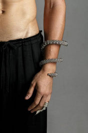 hand picture with handcrafted beaded modular spiral cuff on grey background by object and dawn