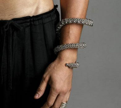 hand picture with handcrafted beaded modular spiral cuff on grey background by object and dawn