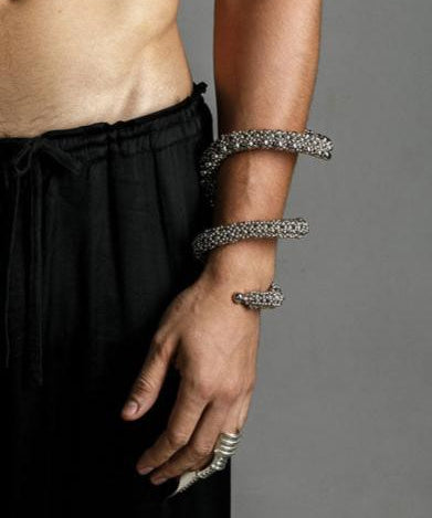 hand picture with handcrafted beaded modular spiral cuff on grey background by object and dawn