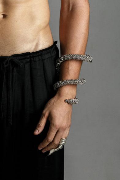 hand picture with handcrafted beaded modular spiral cuff on grey background by object and dawn