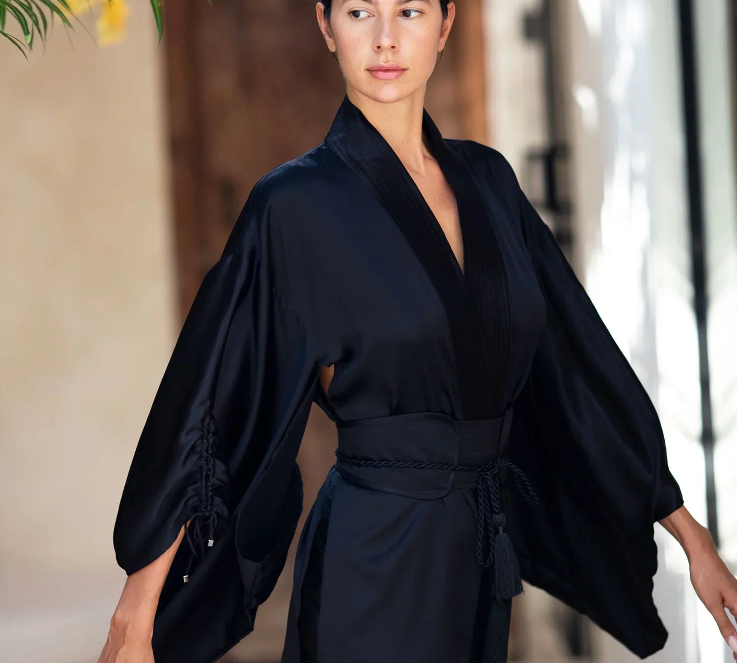 woman wear Mineko Short Silk Kimono with obi belt black posing against natural look background