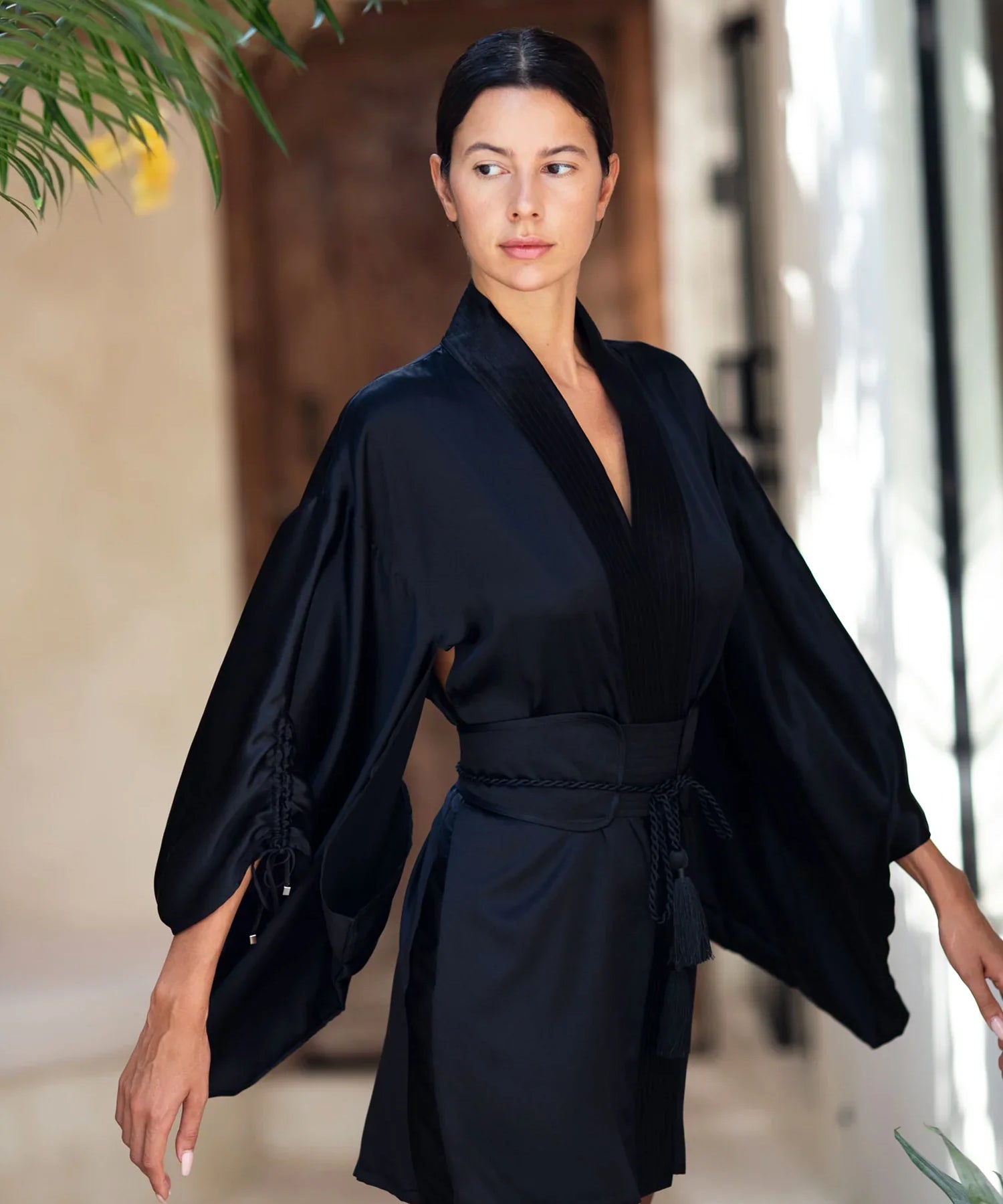 woman wear Mineko Short Silk Kimono with obi belt black posing against natural look background