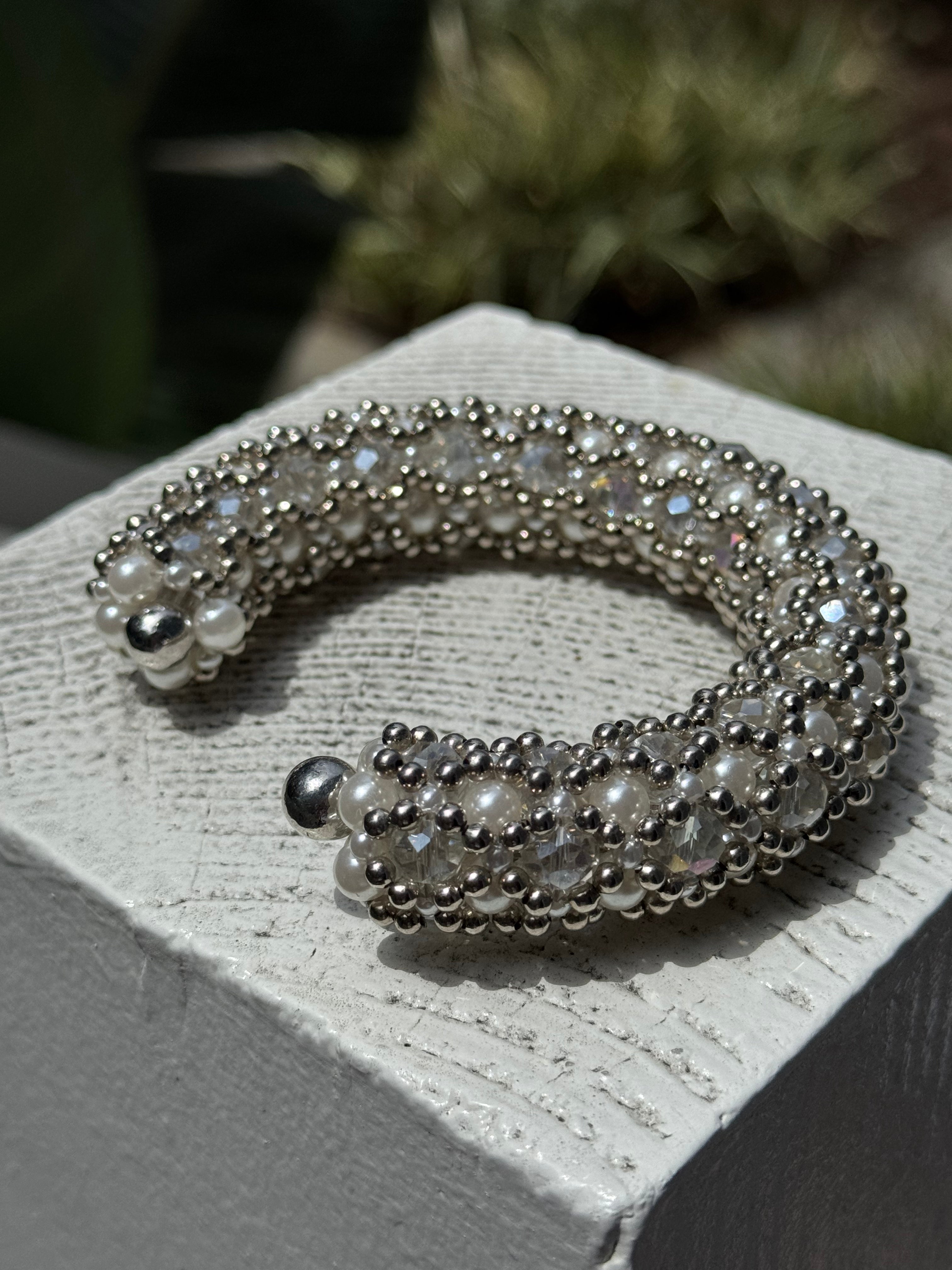 side shoot of handcrafted beaded cuffs with crystal and pearl embellishments in silver tone by object&dawn