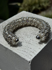 shoot of handcrafted beaded cuffs with crystal and pearl embellishments in silver tone by object&dawn