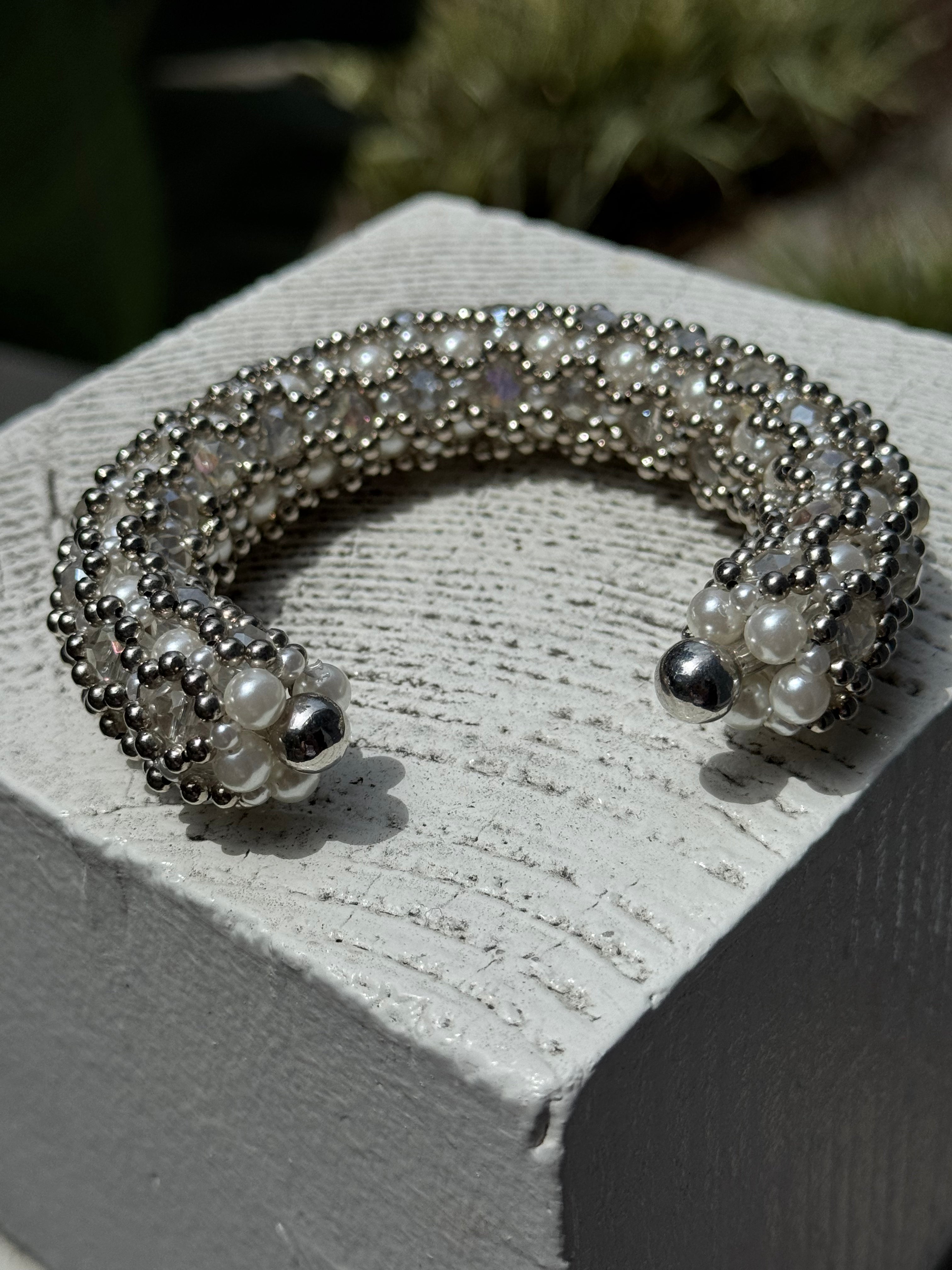 shoot of handcrafted beaded cuffs with crystal and pearl embellishments in silver tone by object&dawn