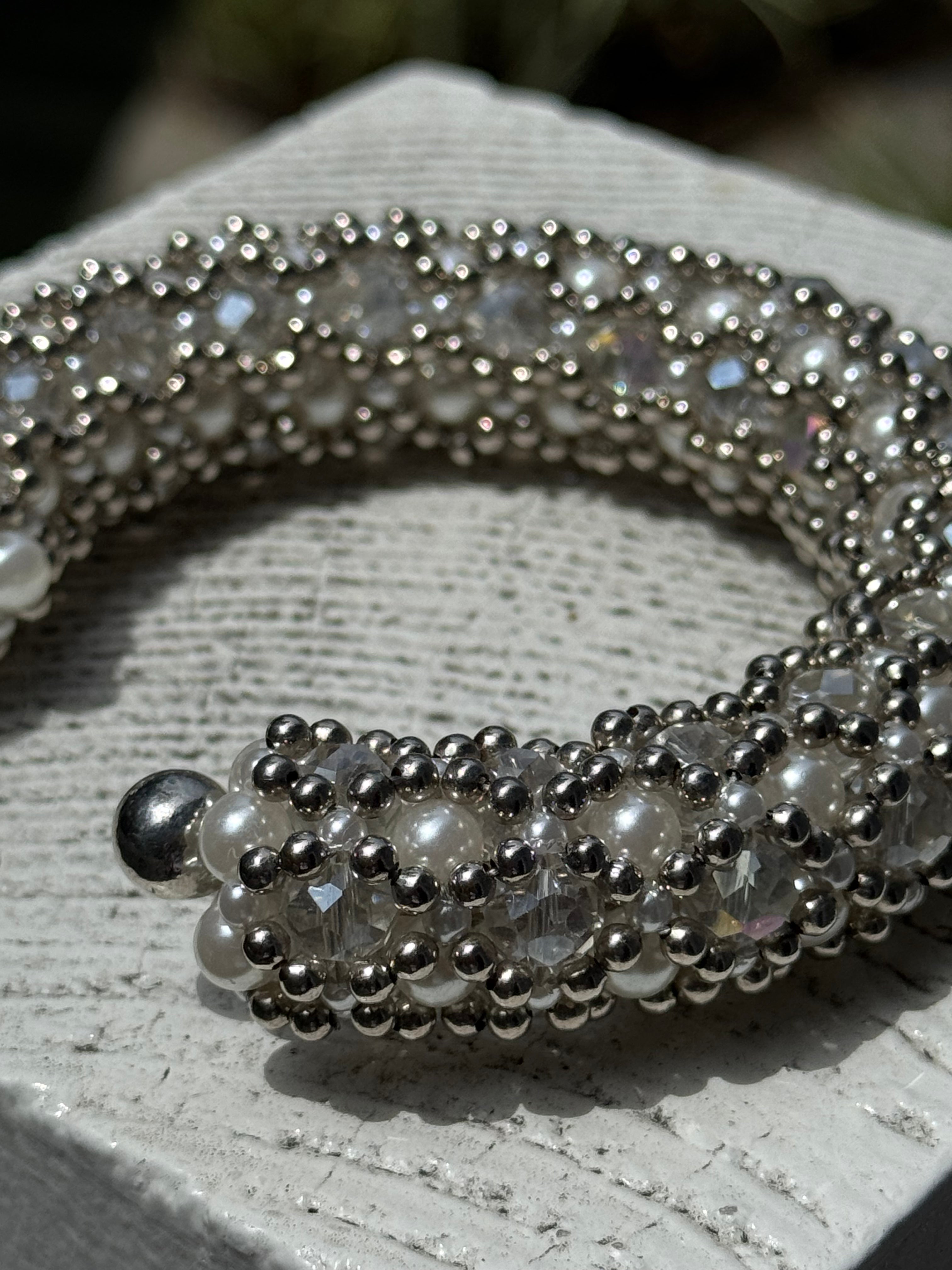 close-up of handcrafted beaded cuffs with crystal and pearl embellishments in silver tone by object&dawn
