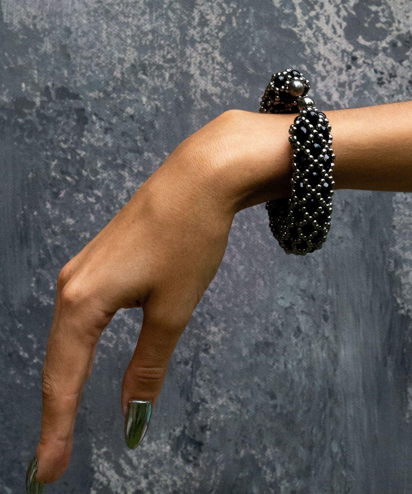 hand with handcrafted beaded nyx supple cuff in jetblack by object and dawn